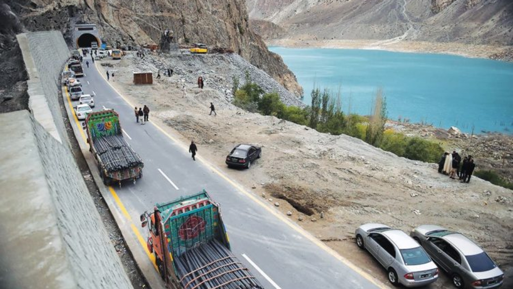 To go with story 'Pakistan-China-economy-transport, FEATURE' by Guillaume LAVALLÉE
In this photograph taken on September 29, 2015, Pakistani commuters wait to travel through a newly built tunnel in northern Pakistan's Gojal Valley. A glossy highway and hundreds of lorries transporting Chinese workers by the thousands: the new Silk Road is under construction in northern Pakistan, but locals living on the border are yet to be convinced they will receive more from it than dust. AFP PHOTO / Aamir QURESHI